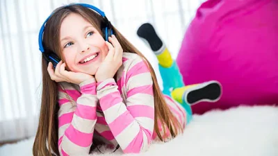 girl on bean pag couch wearing headphones